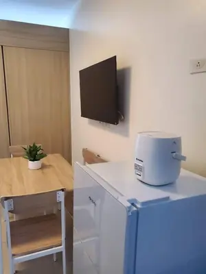 a kitchen with a slow cooker and a tv on the wall at Group Stay by Metro Staycation in Manila