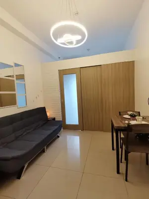a living room with a black couch and a table at Group Stay by Metro Staycation in Manila