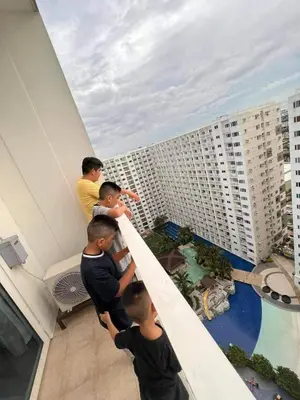 a group of men standing on top of a building at Group Stay by Metro Staycation in Manila