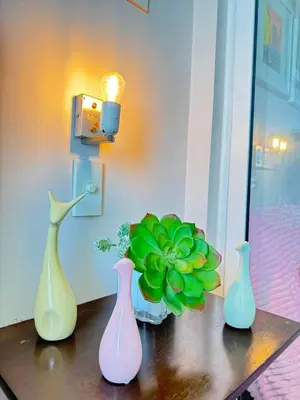 four vases sitting on a table with a plant at Isla Cabana Azure Staycation in Manila