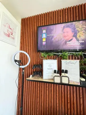 a tv on a wooden wall with three products on a shelf at Isla Cabana Azure Staycation in Manila