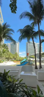 a view of a beach with palm trees and buildings at Isla Cabana Azure Staycation in Manila