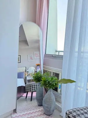 a room with two blue vases and a mirror at Isla Cabana Azure Staycation in Manila