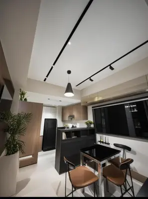 a kitchen with a table and chairs in a room at One Bedroom Apartment near MOA in Manila