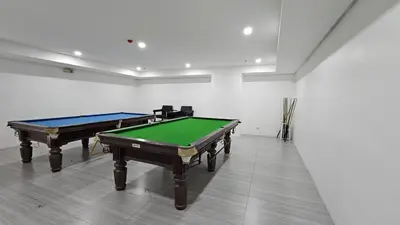 a room with two pool tables and a red ball at Chic Studio near Megamall and Shangrila Plaza in Manila