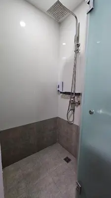 a shower with a glass door in a bathroom at Chic Studio near Megamall and Shangrila Plaza in Manila