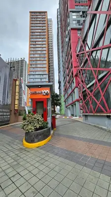 a city street with buildings and a red building at Chic Studio near Megamall and Shangrila Plaza in Manila