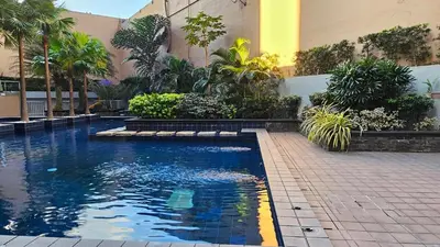 a swimming pool in front of a building at Chic Studio near Megamall and Shangrila Plaza in Manila