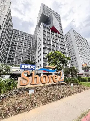 a large sign in front of a large building at Shore 2 Residence in Manila