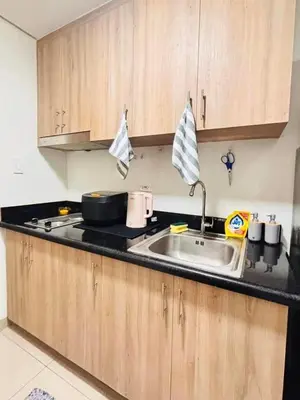 a kitchen with a sink and a counter top at Shore 2 Residence in Manila