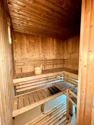 an empty wooden sauna with a bucket in it at Pixie Dust Suite in Manila