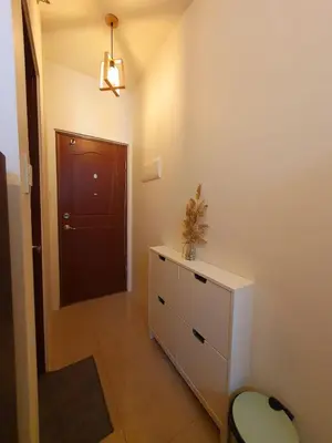 a bathroom with a cabinet and a door and a stool at Pixie Dust Suite in Manila