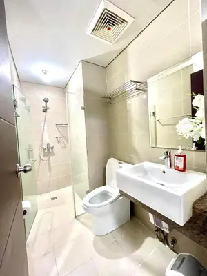 a bathroom with a toilet and a sink at ASD Airport Condotel Pasay in Manila
