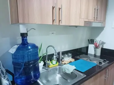 a blue bottle sitting on a sink in a kitchen at Dream City Staycation -Shore3 Residences Tower 2 in Manila