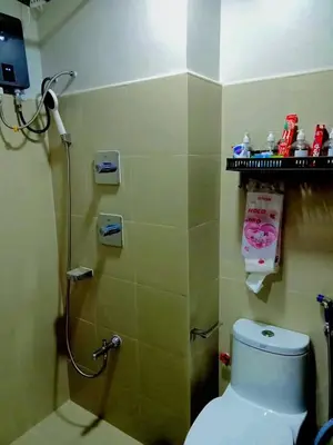 a bathroom with a toilet and a shower in it at Dream City Staycation -Shore3 Residences Tower 2 in Manila