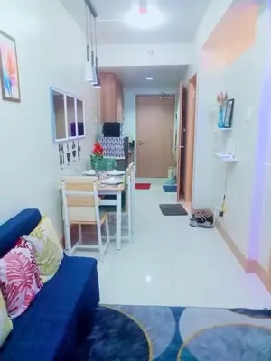 a living room with a blue couch and a table at Dream City Staycation -Shore3 Residences Tower 2 in Manila
