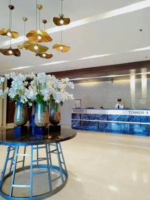 two vases with flowers on a table in a lobby at Dream City Staycation -Shore3 Residences Tower 2 in Manila