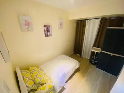 a small bedroom with a bed and a window at Sole Sisters Staycation in Manila