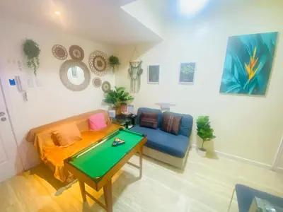 a living room with a pool table and a couch at Sole Sisters Staycation in Manila
