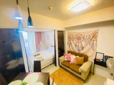 a living room with a couch and a bed at Sole Sisters Staycation in Manila