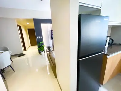 a kitchen with a black refrigerator in a room at Cozy 3BR near Airport & Okada, Solaire II Infinity Pool in Manila
