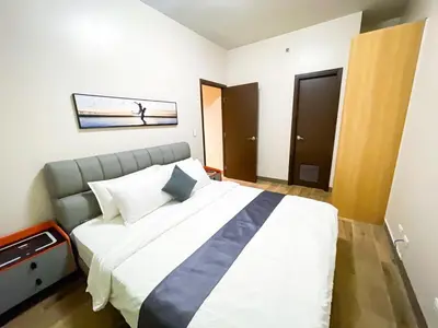 a bedroom with a large bed in a room at Cozy 3BR near Airport & Okada, Solaire II Infinity Pool in Manila