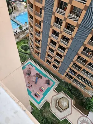 an aerial view of an apartment complex with a swimming pool at Minimalist Haven 3BR unit at Mckinley Hill in Manila
