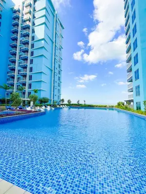 a swimming pool in the middle of two tall buildings at Cozy 2BR Suite near Airport & Okada, Infinity Pool in Manila