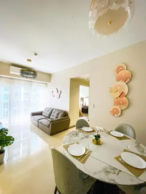 a living room with a table and a couch at Spacious 1BR Suite near Okada, Solaire, Airport in Manila