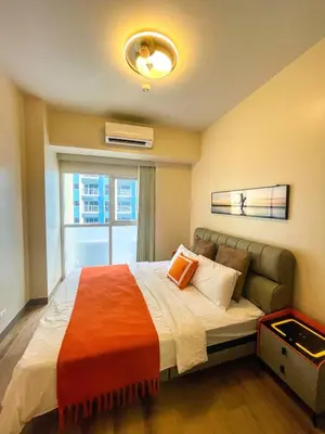 a bedroom with a large bed with a window at Spacious 1BR Suite near Okada, Solaire, Airport in Manila
