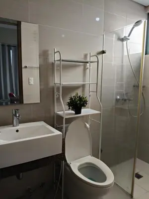 a bathroom with a toilet and a sink and a shower at LDN Two Palm Tree Villa LFamilia in Manila