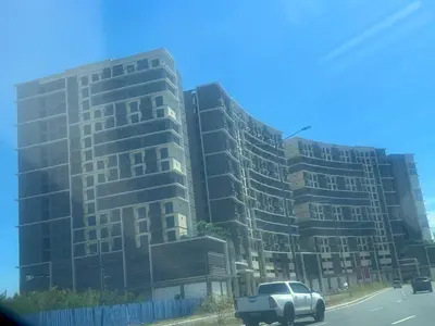 a truck parked in front of a tall building at 1 BR Executive Suite Gentry Manor by JMS in Manila