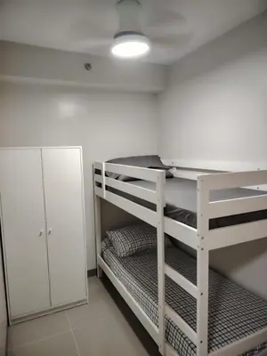 a white bunk bed in a room at Charm Residences Building E in Manila