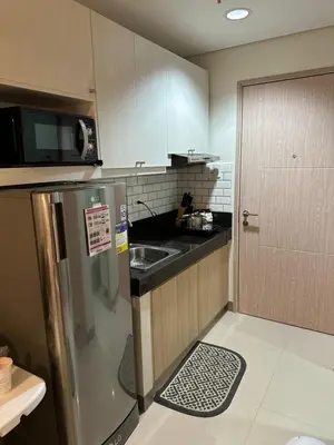 a small kitchen with a sink and a refrigerator at Charm Residences Building E in Manila