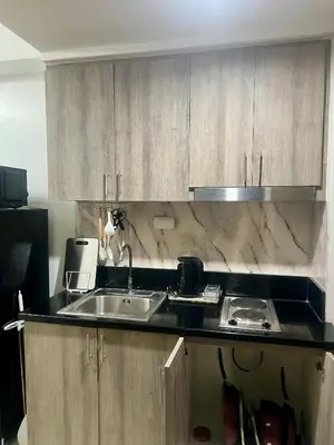 a kitchen with a sink and a counter top at 1 Br Family Suite in S Residences by JMS in Manila