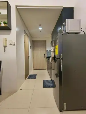 a hallway with a refrigerator in a room at Shore Residences MOA Minimalist Room in Manila