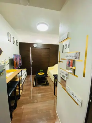 a room with a bed and a desk and a bedroom at Stylish Condo in Makati City with stunning views in Manila