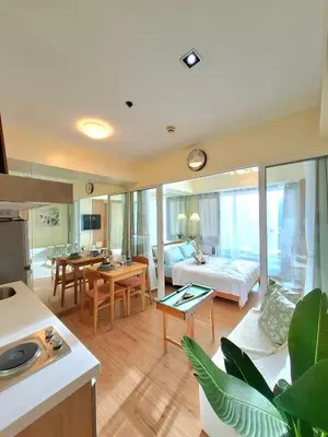 a living room with a bed and a living room at Azure Condotel and Resort in the City in Manila