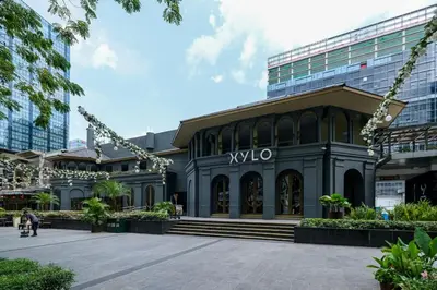 a building with a sign on the front of it at Cozy 2BR Suite in Uptown BGC with PS4 and walking distance to Malls and Restaurants in Manila