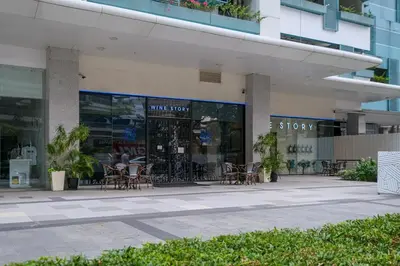 a store with tables and chairs outside of a building at Cozy 2BR Suite in Uptown BGC with PS4 and walking distance to Malls and Restaurants in Manila