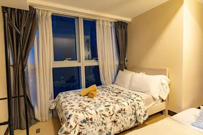 a bedroom with a bed with a stuffed animal on it at Spacious 3BR Suite in Uptown BGC with King Size Bed, near Malls and Restaurants in Manila