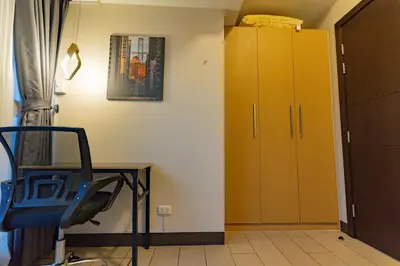 a room with a desk and a yellow cabinet at Spacious 3BR Suite in Uptown BGC with King Size Bed, near Malls and Restaurants in Manila