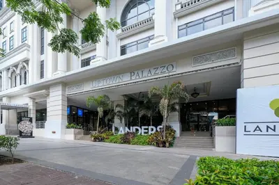 a large white building with a sign that reads luton palacio at Spacious 3BR Suite in Uptown BGC with King Size Bed, near Malls and Restaurants in Manila