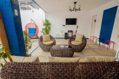 a living room with chairs and a table and a tv at Private Resort in upper Antipolo in Antipolo