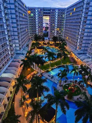 an aerial view of a resort with palm trees and buildings at 1528 pool view with balcony in Manila