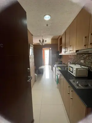 a kitchen with a door open to a hallway at 1528 pool view with balcony in Manila