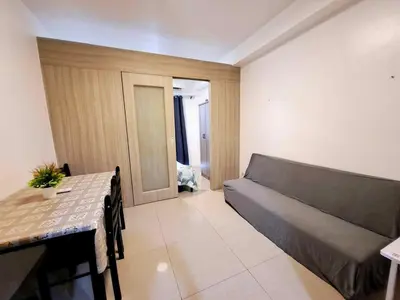 a living room with a couch and a table at Wooden style amenities view in Manila