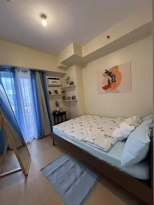 a bedroom with a bed in a room at Bless View at 16th in Manila