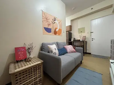 a living room with a couch and a table at Bless View at 16th in Manila