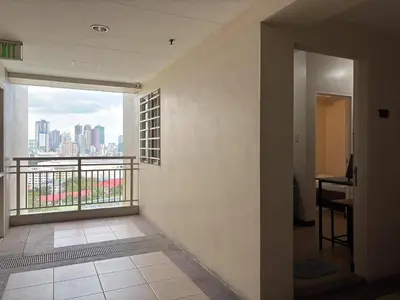 a room with a balcony with a view of a city at Bless View at 16th in Manila